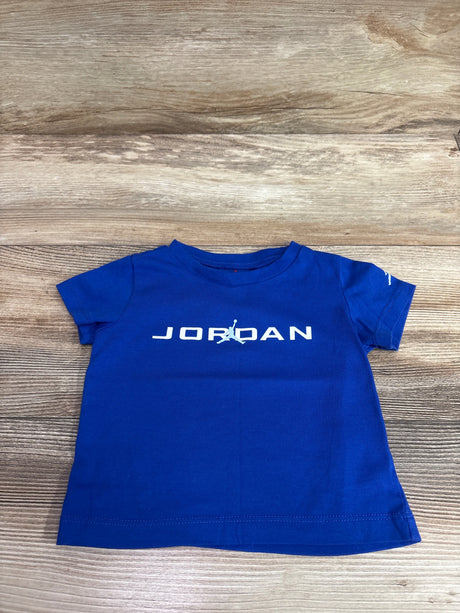 Blue Jordan baby t-shirt with white logo on a light wood surface