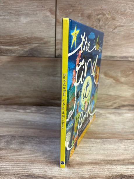 Side view of The Find It Book hardcover showing yellow spine and colorful illustrated front cover on wooden plank background