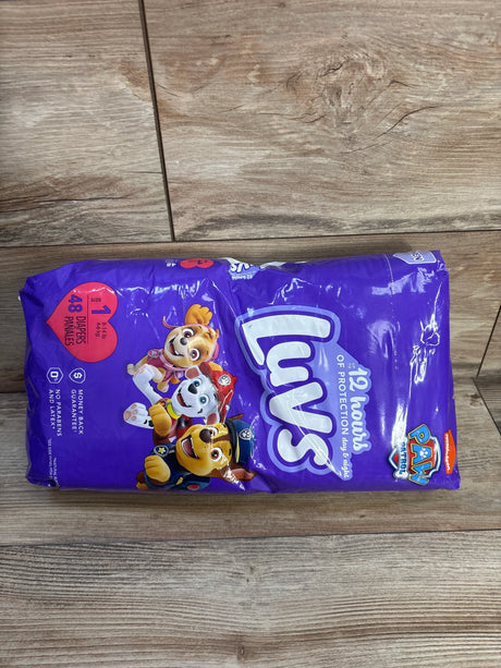 Top view of Luvs Paw Patrol diaper pack, size 1 (48 ct), purple packaging with Paw Patrol characters on wood floor
