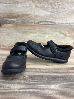Black toddler Mary Jane shoes with Velcro straps on wood background