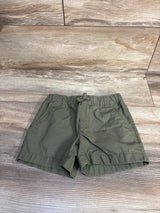 Flat lay of Carter's toddler drawstring shorts in olive green showing elastic waistband and front pockets on wood background