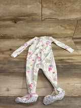 Front view of Just One You white blanket sleeper in size 12m showcasing candy pattern and footed design on wood floor
