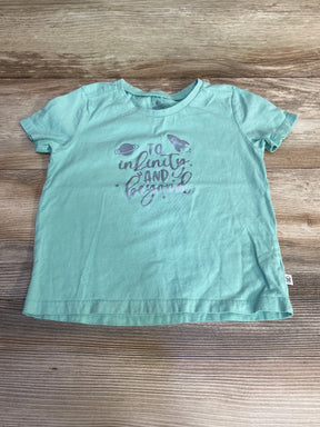 Flat lay of mint green toddler short-sleeve shirt (4T) showing "To infinity and beyond" script with rocket and planet graphics on wood background