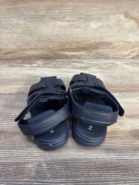 Rear view of navy Nautica Fisherman sandals size 9C showing adjustable straps and cushioned footbed on wood background