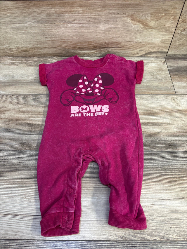 Front flat lay of pink Disney romper showcasing Minnie bow graphic and text BOWS ARE THE BEST on wood background