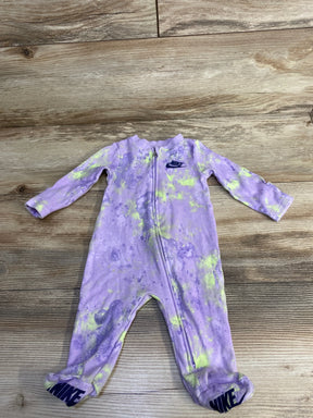 Purple and yellow tie-dye Nike baby onesie with zipper and logo on chest and feet on wooden floor