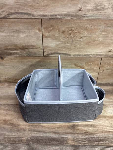 Front view of Munchkin Portable Diaper Caddy Organizer showing grey fabric, divided interior, and carry handles