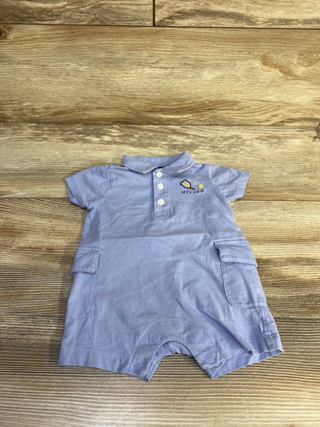 Top view of Carter's blue polo romper (3M) with short sleeves, button placket, side pockets and snap leg closures on wood