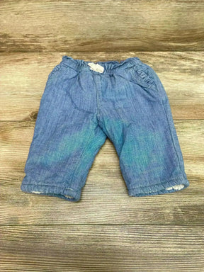 Front view of Gap chambray baby pants size 0-3M showcasing elastic waistband and sherpa-lined cuffs on wooden floor background