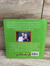 Back of Austin Loves His Family hardcover showing green back with author photo, blurb, logo and barcode on wood background