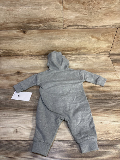 Flat-lay back view of grey Nike hooded baby coverall size 3M showing attached hood and cuffed sleeves on wood background