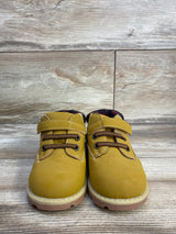 Front view of Garanimals toddler boots (size 6C) showcasing hook-and-loop strap and faux-lace detail with light wood background