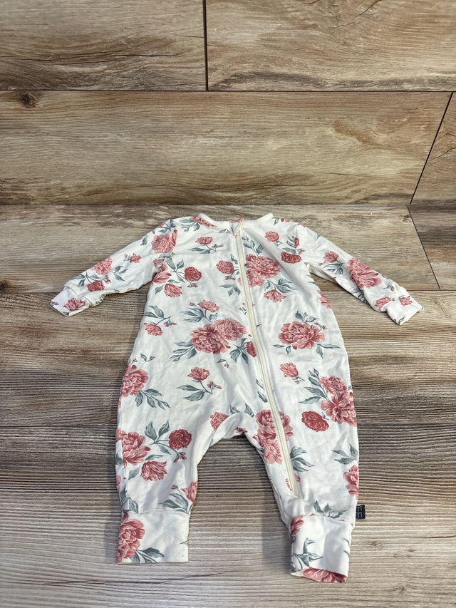 Front flat lay of ivory footless baby sleeper showcasing pink floral print, front zipper, long sleeves, and cuffed ankles on wood background