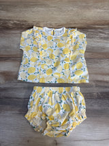 Baby girl lemon print top and bloomers set on wooden background
