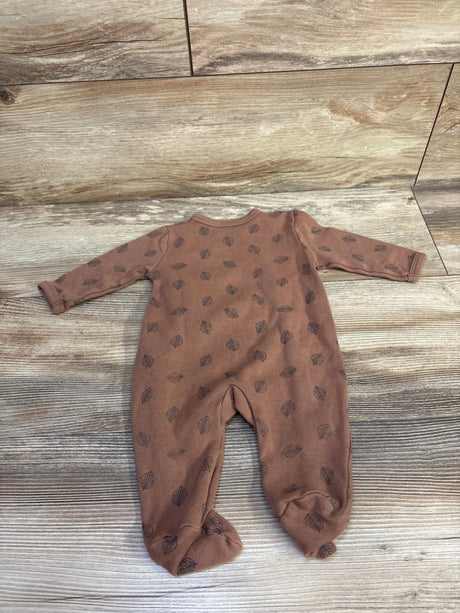 Flat-lay of Ecojoy kimono sleeper, size 3 months, brown with leaf print, footed legs and long sleeves on wood floor
