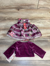 Top view of purple floral baby dress with shadow-striped organza overlay and matching velvet shrug on wood floor