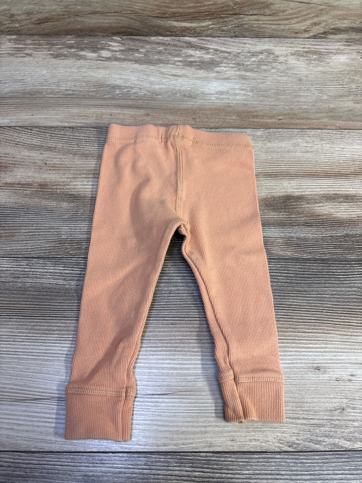 Zara ribbed leggings in orange for baby size 9-12m on a grey wood background