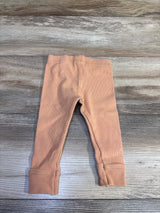 Zara ribbed leggings in orange for baby size 9-12m on a grey wood background
