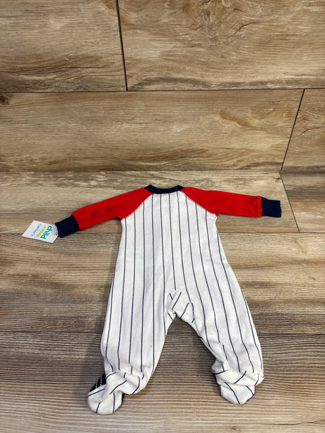 Top view of Child Of Mine Daddy’s Champ sleeper showcasing white fabric with navy pinstripes, red sleeves, and footed legs on wood flooring