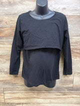 Front view of black Smallshow maternity nursing shirt showcasing two-layer nursing access with wood-look background