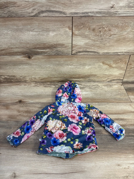 Flat-lay of Posh P reversible baby hoodie (6–12 months) showing blue floral print, hood, and long sleeves on wood floor