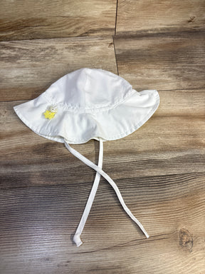 Top-down view of iPlay swim bucket hat in white showing wide brim, chin ties, and yellow star button on wood background