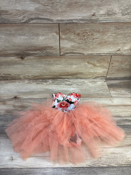 Flat lay of 12-18 month floral tulle tutu dress showing layered coral tulle skirt and rose print on wood background