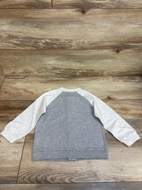 Back view of First Impressions full zip jacket in gray showcasing light gray raglan sleeves, ribbed trim on wood background