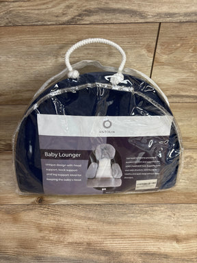 Antolik baby lounger in packaging with head and back support, placed on wood floor