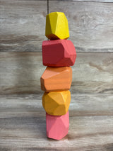 Front of Lovevery Solid Wood Stacking Boulders 5pc, five faceted wooden blocks stacked on wood surface