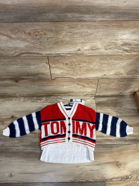 Red and navy striped Tommy Hilfiger baby cardigan with white shirt on wood floor