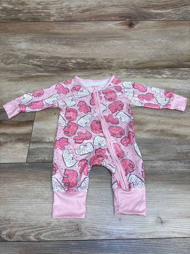 Top view of pink Shein Animal Cracker sleeper with front zipper and animal cracker print on a wood-look background