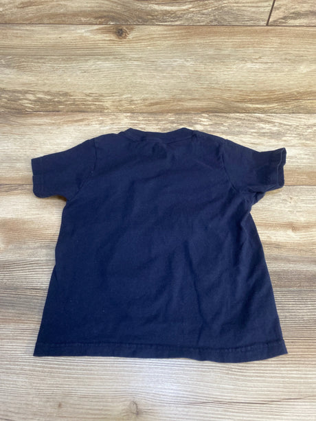 Navy blue short sleeve toddler t-shirt on wood background, children's clothing
