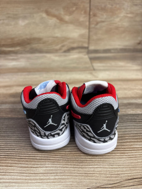 Rear view of Air Jordan Legacy 312 Low TD Chicago Flag sneakers showing red collars and elephant print on wood