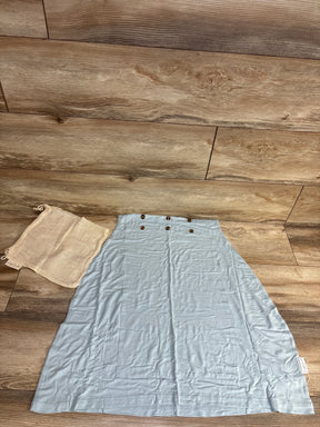 Top-down view of Snuggle Shield LUXE nursing/car seat cover, light blue, with front snap buttons and mesh bag on wood floor