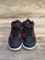 Front view of toddler AND1 black lace-up basketball sneakers showing red accents and Velcro ankle strap on wood background