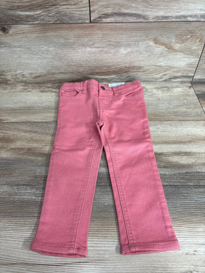 Front view of Okie Dokie toddler skinny jeans in bohemian rose showing slim legs and five pocket detail on wood background