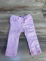Front view of pink Old Navy toddler rockstar jeggings showing three-button fly and faux front pockets on light wood background