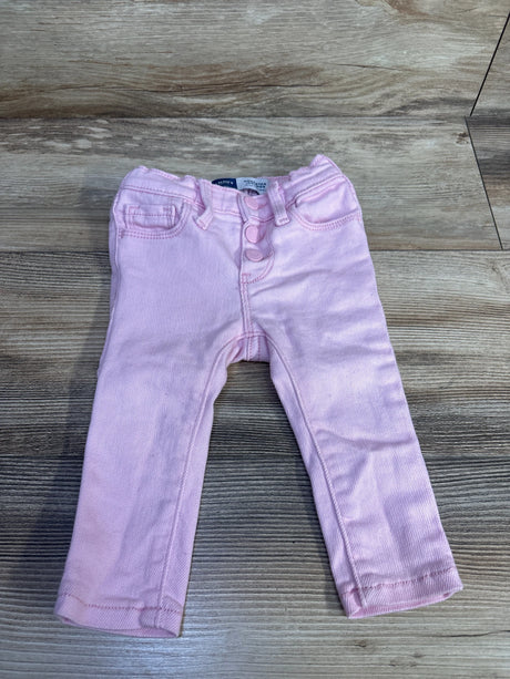 Front view of pink Old Navy toddler rockstar jeggings showing three-button fly and faux front pockets on light wood background
