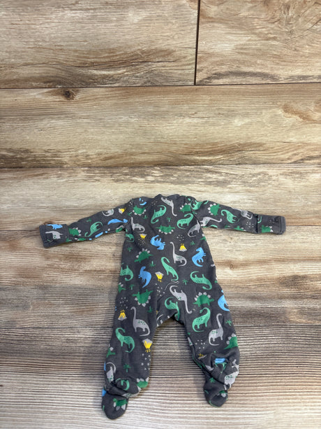 Flat lay of grey preemie dinosaur sleeper showing long sleeves, built-in feet, and green-blue dinosaur print on wood plank background