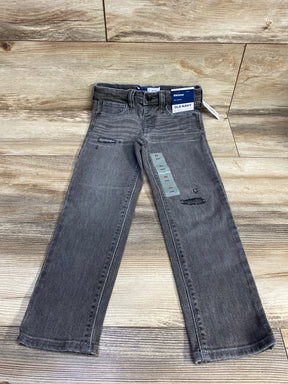 Gray kids skinny jeans with distressed details and Old Navy tag on wood floor