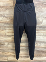 Front view of black maternity leggings (size Large) showcasing high fold-over waistband and cuffed ankles on a wood plank background