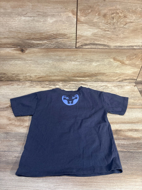 Back view of navy Marvel Black Panther toddler T-shirt, size 3T, showing blue panther face emblem at upper back on wood background