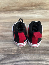 Rear view of Vans Racer Mid sneakers in black and red with pull tabs and Vans 'Off The Wall' logo on wood floor
