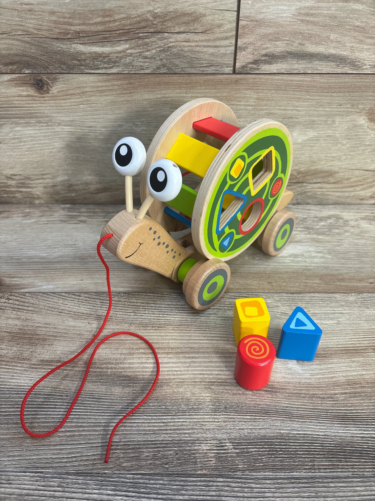 Hape Walk-A-Long Snail Shape Sorting Pull Toy