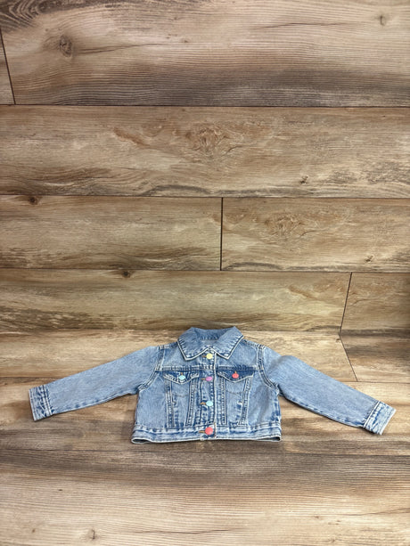 Old Navy blue denim jacket for toddlers size 2T with colorful buttons on a wood background