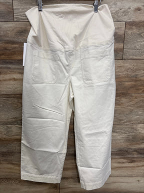 White maternity pants with elastic waistband and back pockets, displayed on wood background.