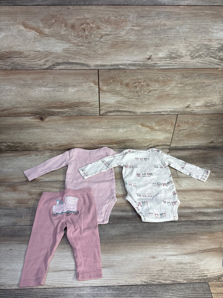 Flat lay of Carter's 3-piece 6M bodysuit set showing a pink striped long-sleeve bodysuit, an ivory long-sleeve bodysuit with small prints, and pink leggings with a train applique on wood backdrop