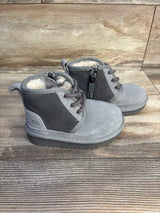 Three-quarter view of Ugg Neumel II boots in grey suede with shearling lining, side zipper and laces on wood background