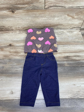 Flat lay of Carter's 2pc fleece vest and leggings, 6M, brown heart-print vest and dark leggings on wood background